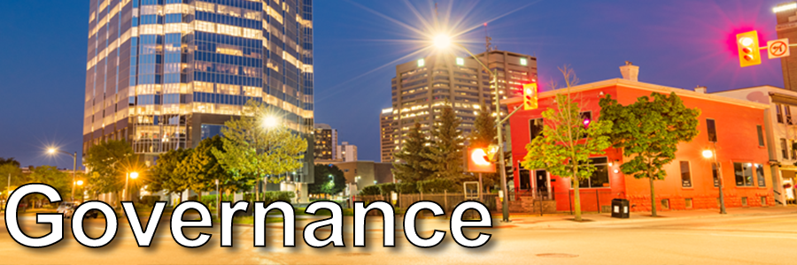 London's downtown at night with city lights glowing with the title Governance placed over the image