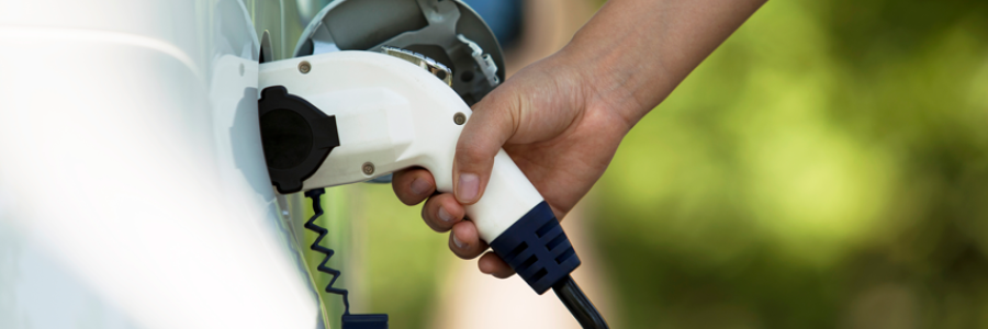 electric vehicle charger being plugged into a car