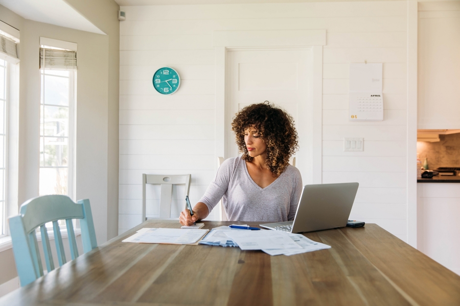 Woman working at a kitchen table