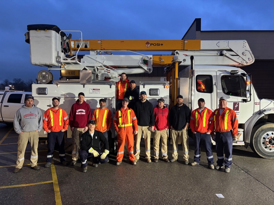crew standing in from of bucket truck