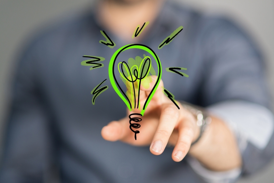 man pointing at a cartoon lightbulb 