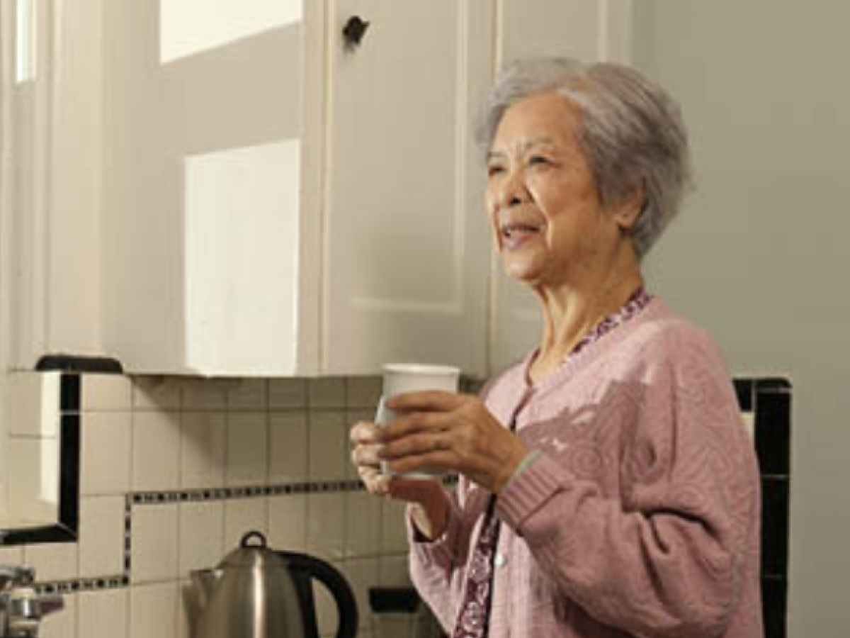 Elderly woman drinking a cup of tea