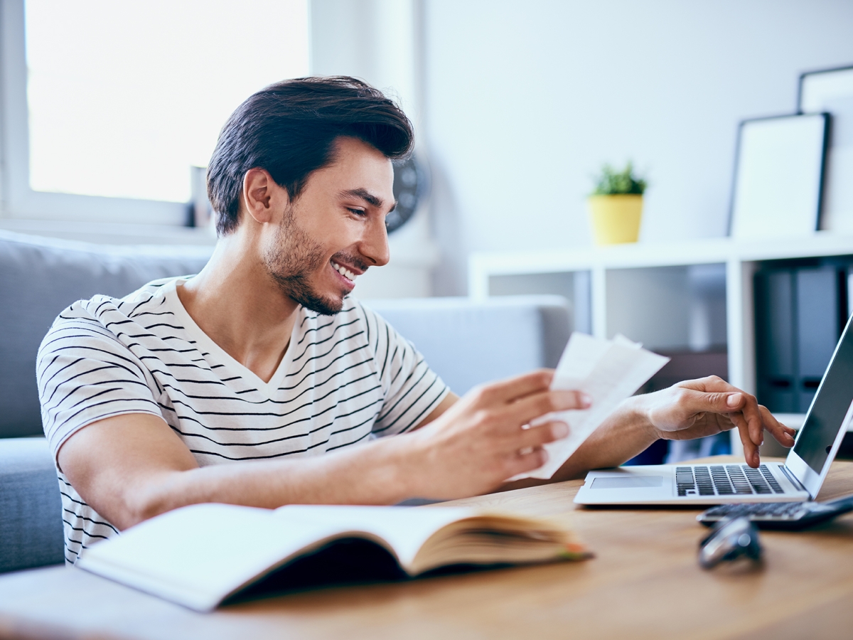 Man sitting in front of his computer viewing his bill
