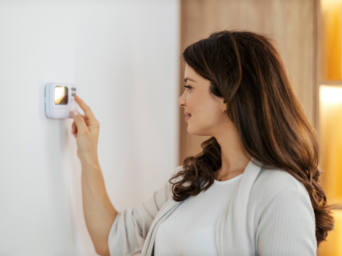 woman using a thermostat