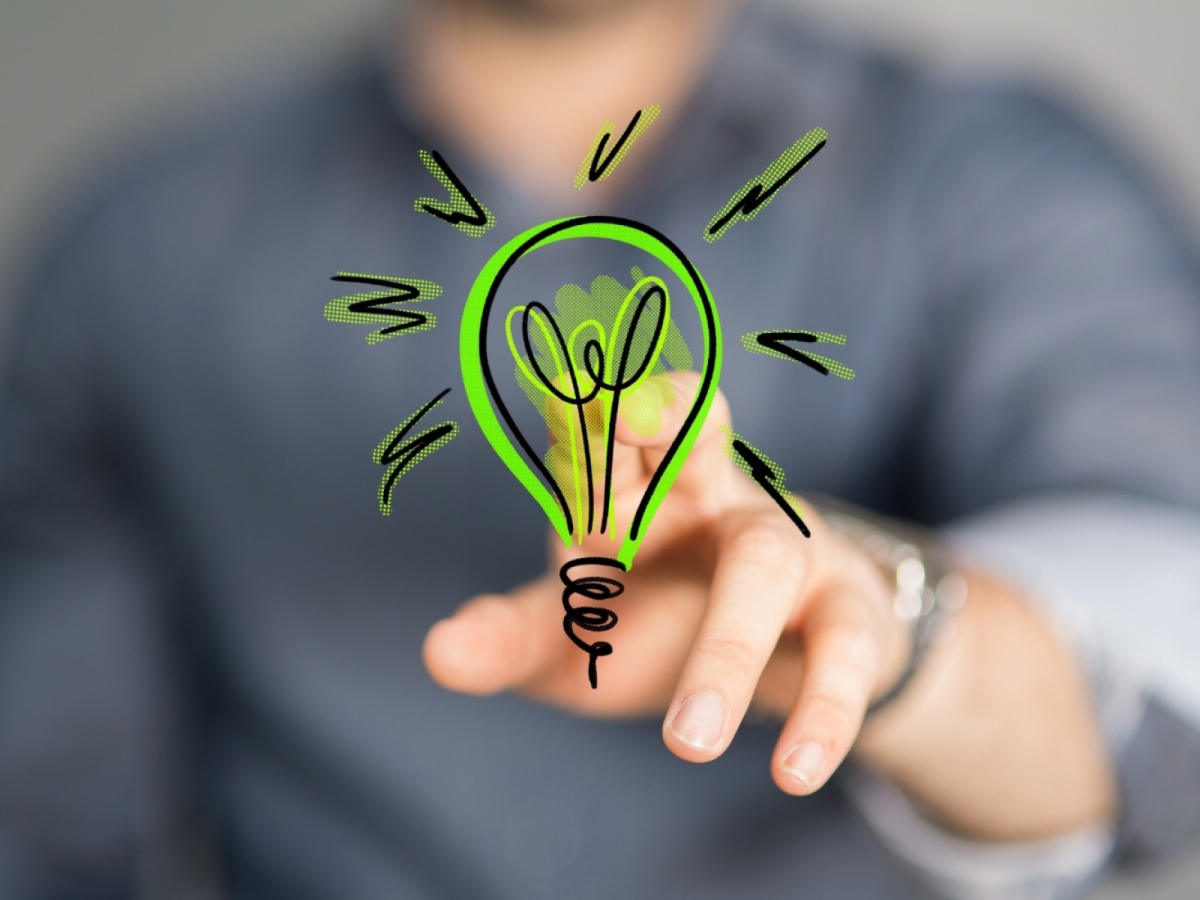 man pointing at a cartoon lightbulb