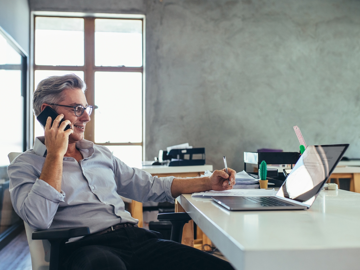 Man on the phone working at his desk