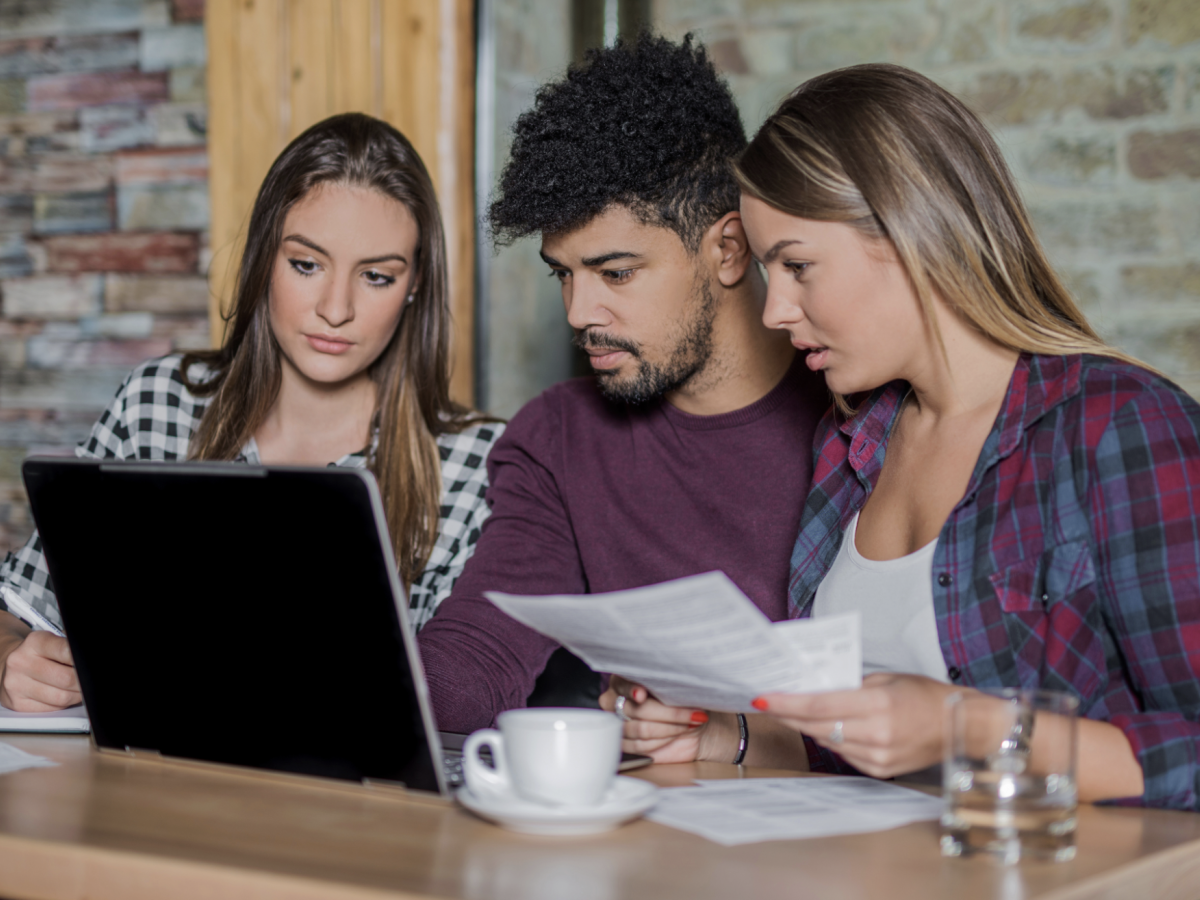 Group of young adults looking at a laptop screen